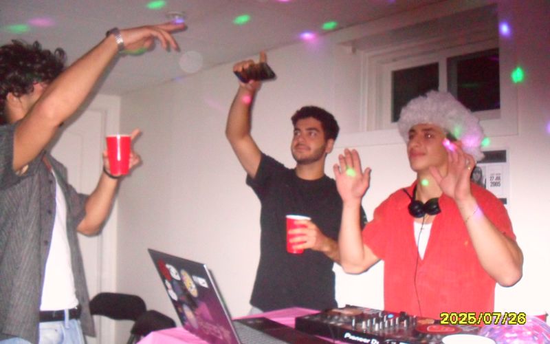 DJing at a house party behind a Pioneer controller