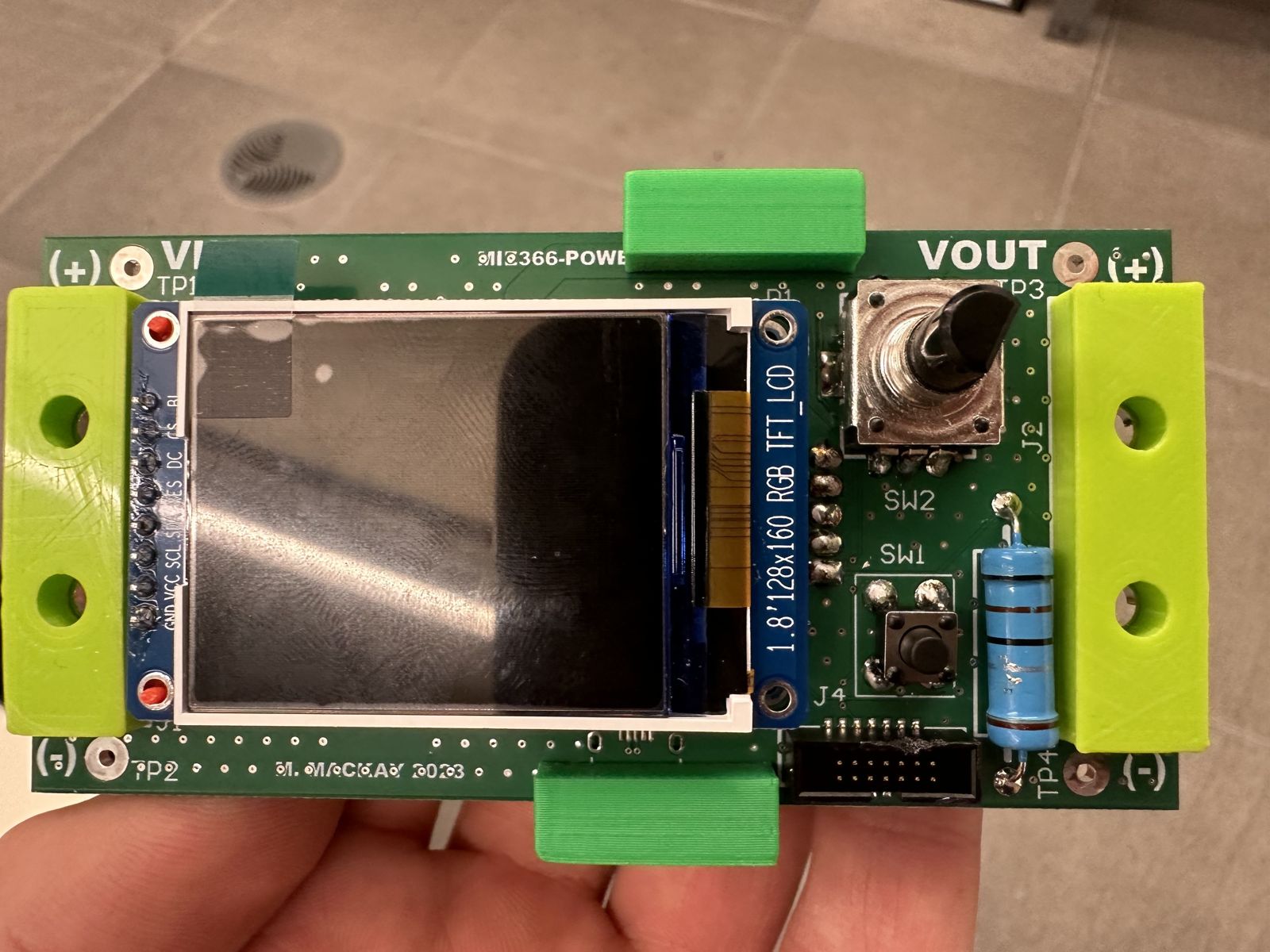 Front of the board: LCD screen, rotary knob and button, held in 3D-printed clips