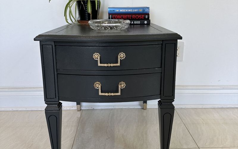 Restored side table painted black with brass pulls